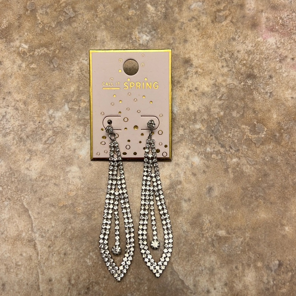 Silver long sparkly earrings. Never worn with price tag.